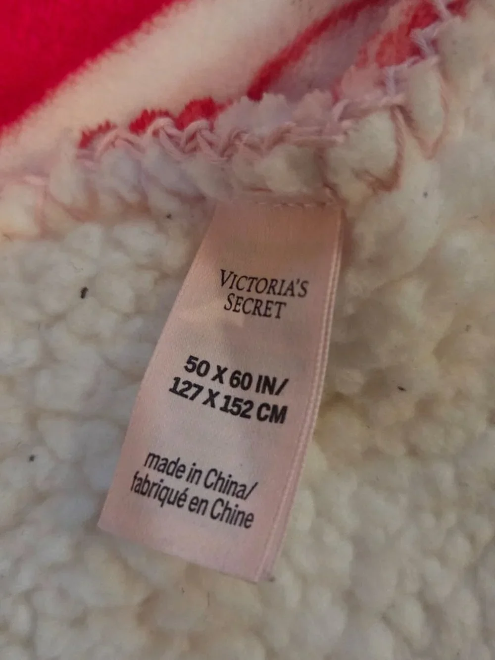 Victoria's Secret Cozy Plush Blanket features cozy white sherpa fleece on the re